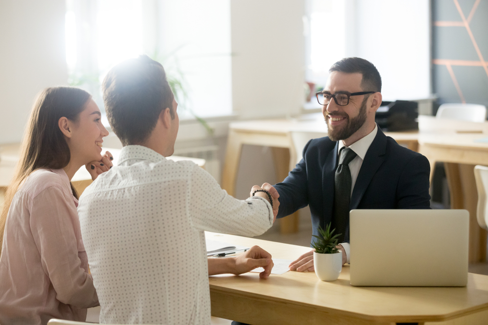 Couple in discussion with insurance broker