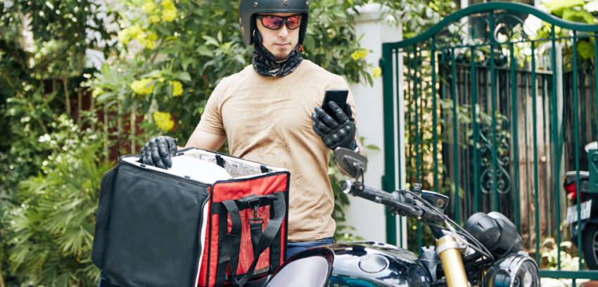 in helmet and protective glasses checking a delivery order
